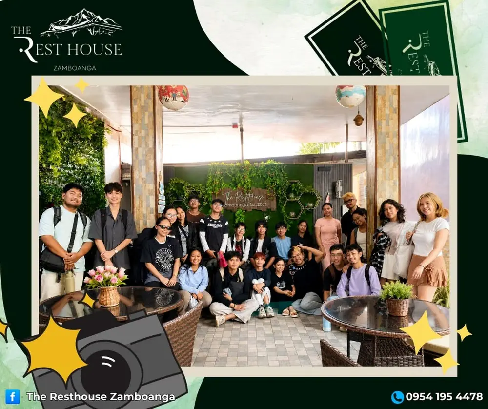 A group of students posing with their bags in the resort lounge